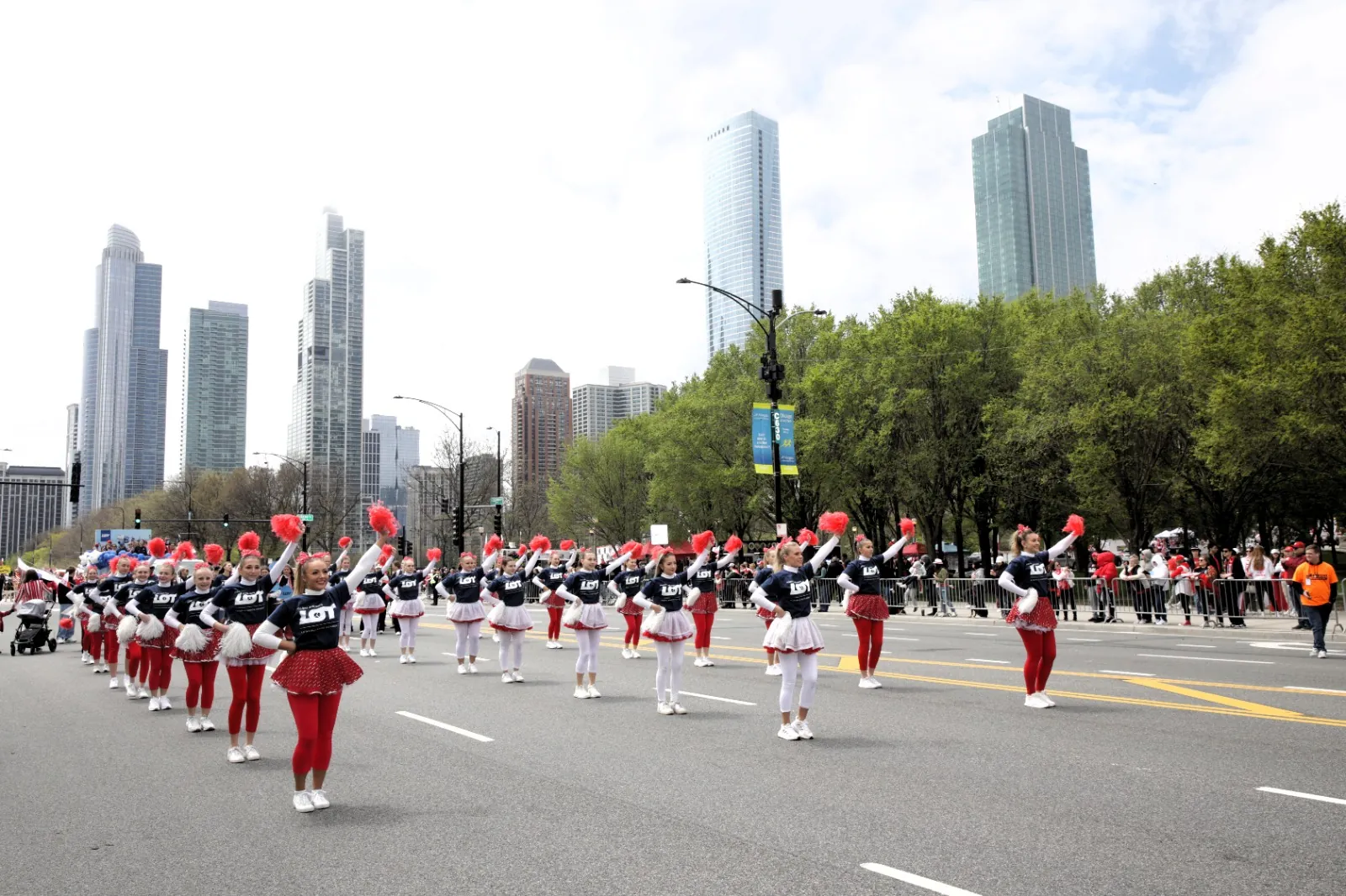 LOT Polish Airlines dance team with red pom-poms marching in a parade in downtown Chicago, 2025
