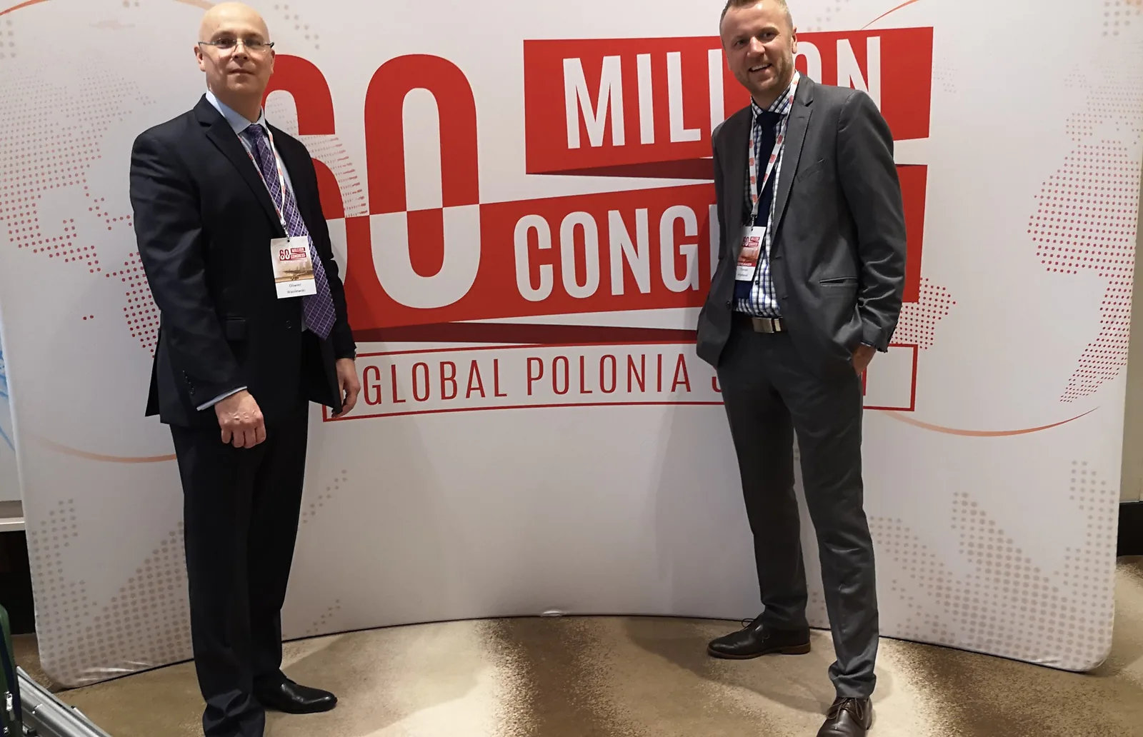 Olivier Wasilewski of Ingressus with another speaker in front of the 60 Million Congress Global Polonia Summit backdrop in Miami, 2019