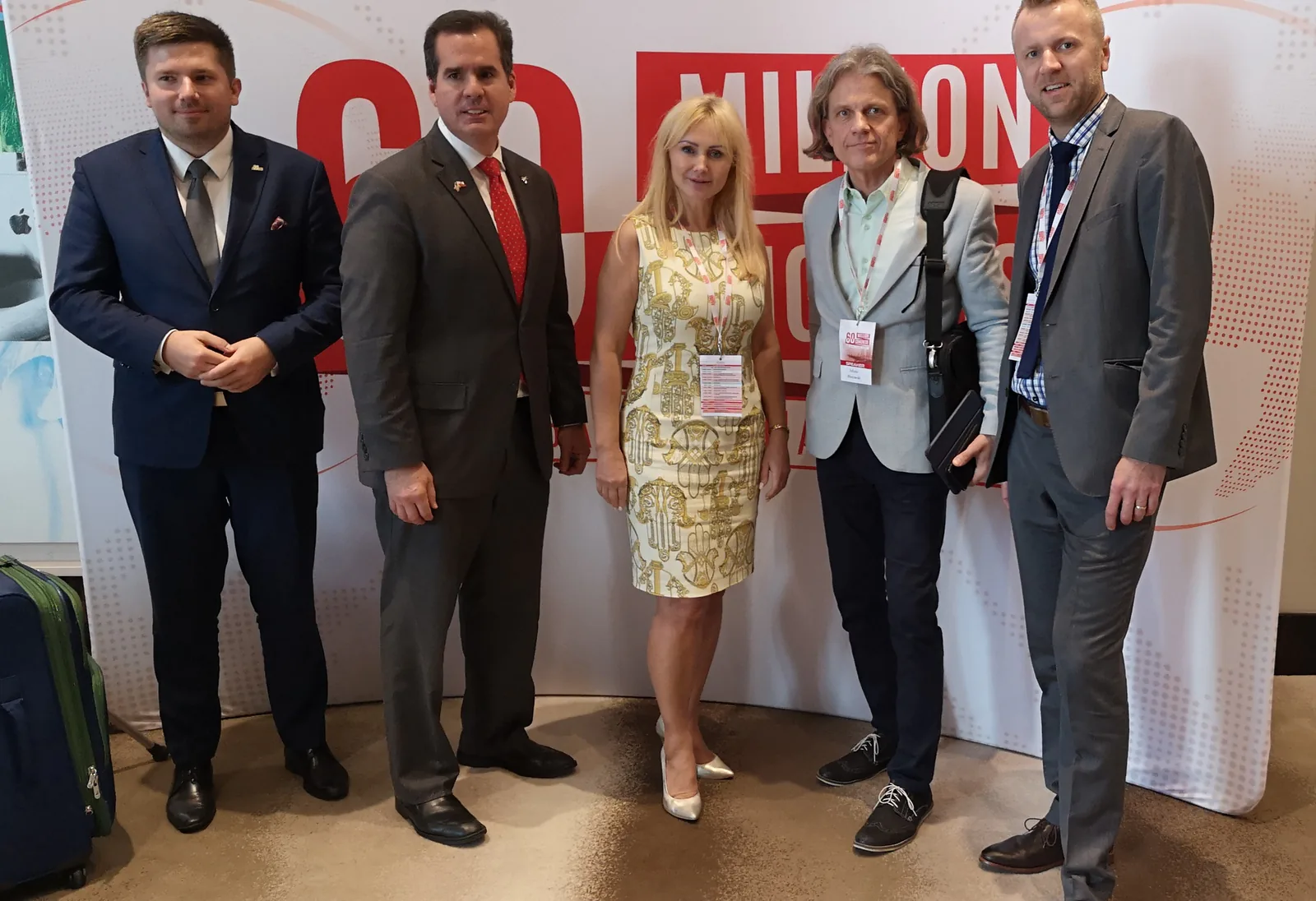 Five congress participants posing in front of the 60 Million Congress Global Polonia Summit backdrop in Miami, February 2019
