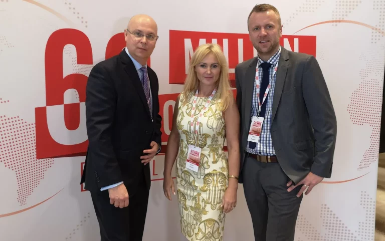 Tomasz Popławski of Ingressus with speaker Beata Drzazga and another participant in front of the 60 Million Congress backdrop in Miami, February 2019