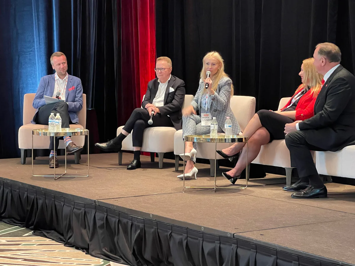 Panelist speaking into a microphone during a panel discussion on stage at the 60 Million Congress in Miami