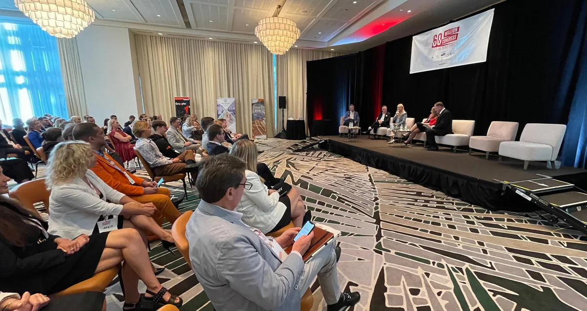 Wide view of a ballroom audience following a panel of five speakers on stage at the 60 Million Congress in Miami