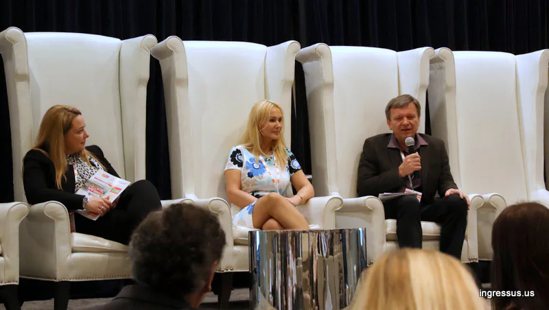 Three panelists in tall white armchairs during a discussion at the 60 Million Congress, one speaking into a microphone