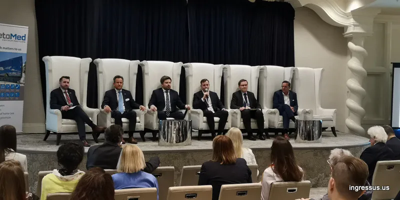 Six panelists in suits seated in tall white armchairs during a 60 Million Congress panel in Miami Beach