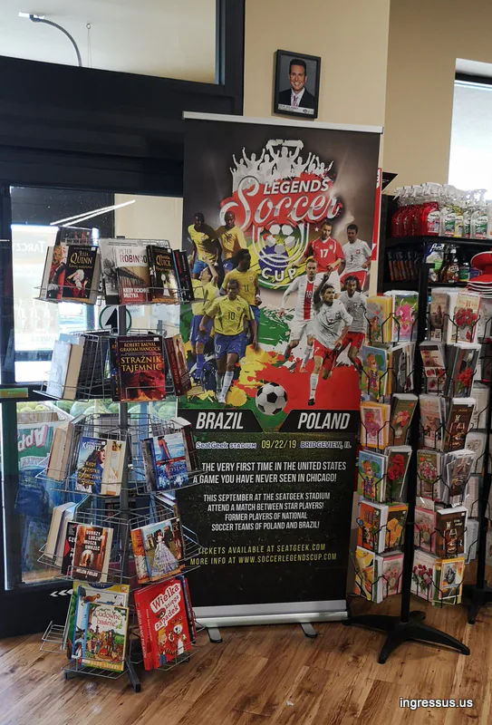 Soccer Legends Cup roll-up banner at the entrance of a Polish bookstore, between racks of books and greeting cards