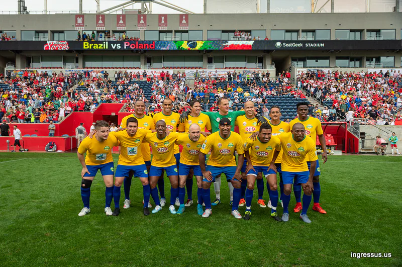 Brazil Legends team in yellow jerseys posing on the pitch at SeatGeek Stadium before the Soccer Legends Cup match against Poland