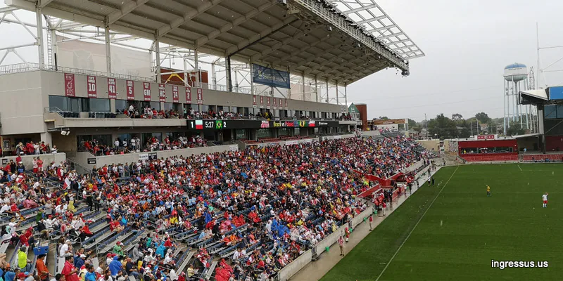 Stands filled with fans in red and yellow at SeatGeek Stadium during the Brazil vs. Poland match, with the scoreboard in view