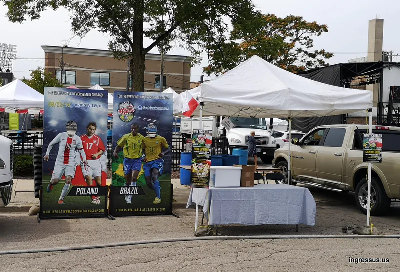 Soccer Legends Cup ticket promo tent with Poland and Brazil photo boards at a street festival