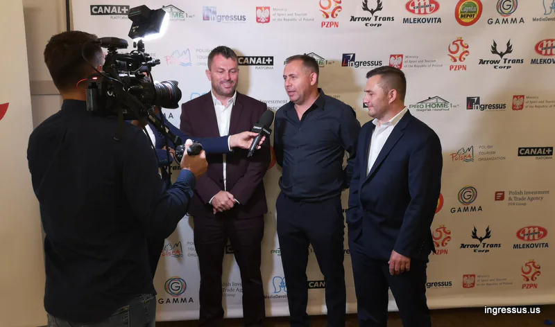 TV crew interviewing three men with a Canal+ microphone in front of the sponsor wall at the Soccer Legends Gala