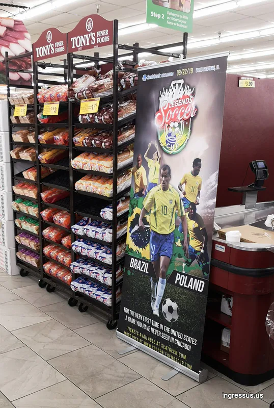 Soccer Legends Cup roll-up banner by the bread racks and checkout at a Tony's Finer Foods grocery store