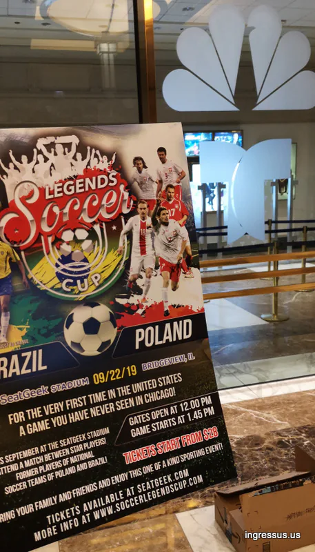 Soccer Legends Cup poster displayed in a building lobby next to the NBC peacock logo
