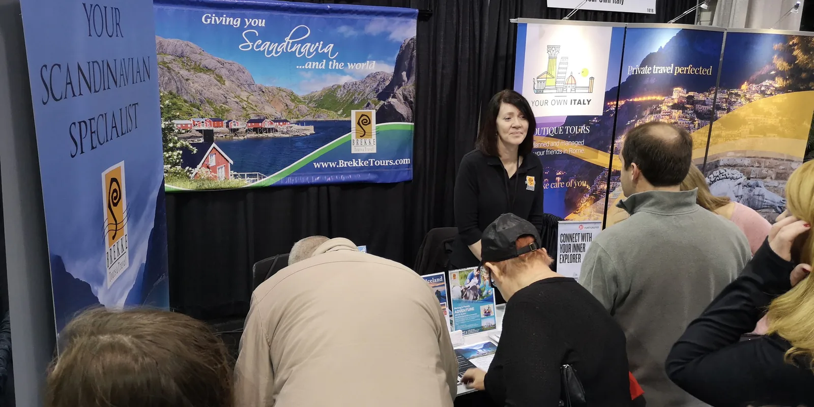 Visitors at the Brekke Tours Scandinavian travel booth next to the Your Own Italy stand at the Chicago Travel & Adventure Show 2019