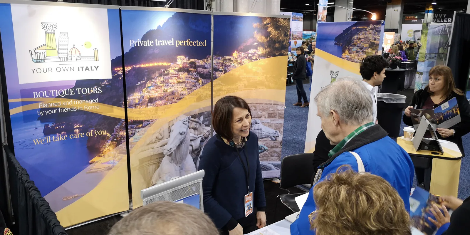 Exhibitor at the Your Own Italy boutique tours booth talking with visitors at the Chicago Travel & Adventure Show 2019 in Rosemont
