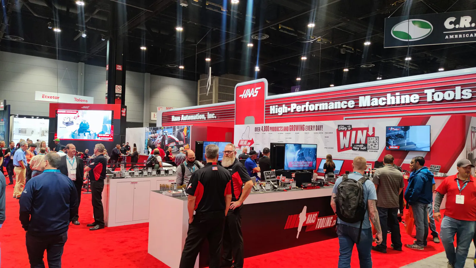 Haas Automation High-Performance Machine Tools exhibit on a red carpet at IMTS 2022, with visitors at the displays