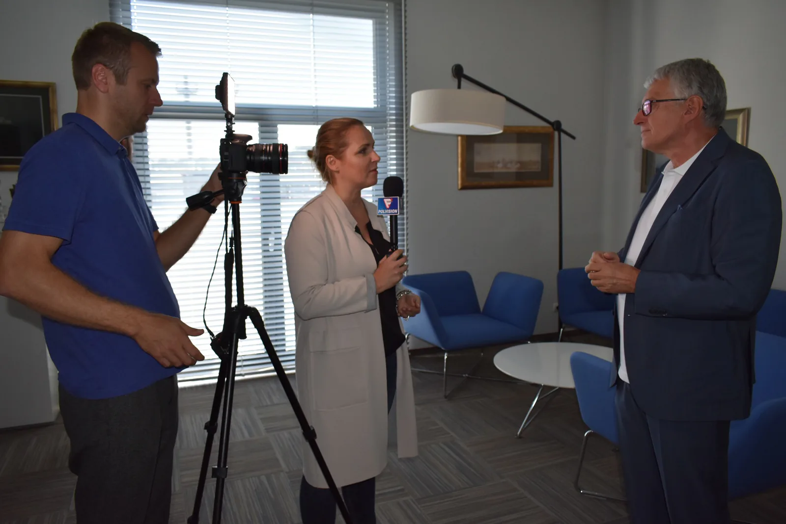 Polvision TV reporter with a microphone and a camera operator recording an interview at American Heart of Poland
