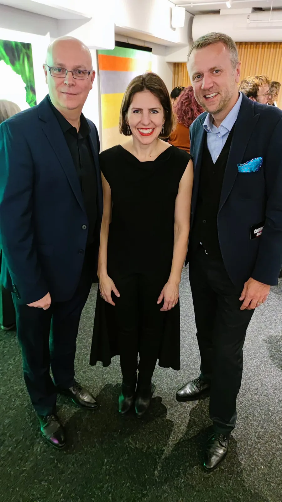 Three guests in evening wear posing together at a reception for Chicago Opera Theater's King Roger