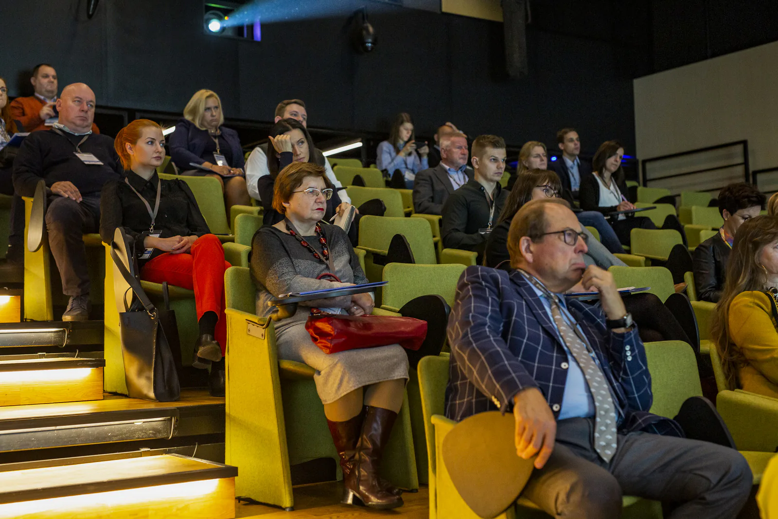 Audience in the green seats of the ICE Kraków auditorium listening to a session of the medical tourism congress