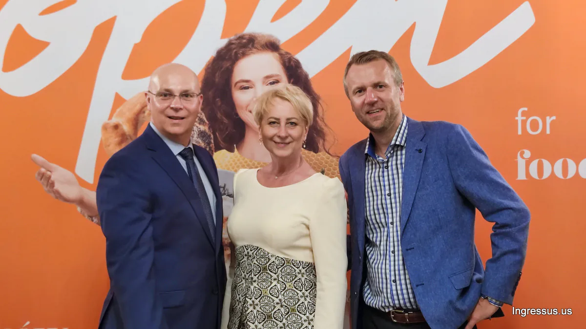 Iwona Gibas, Vice-Marshal of the Małopolska region, with two guests in front of the orange Open for food banner in New York