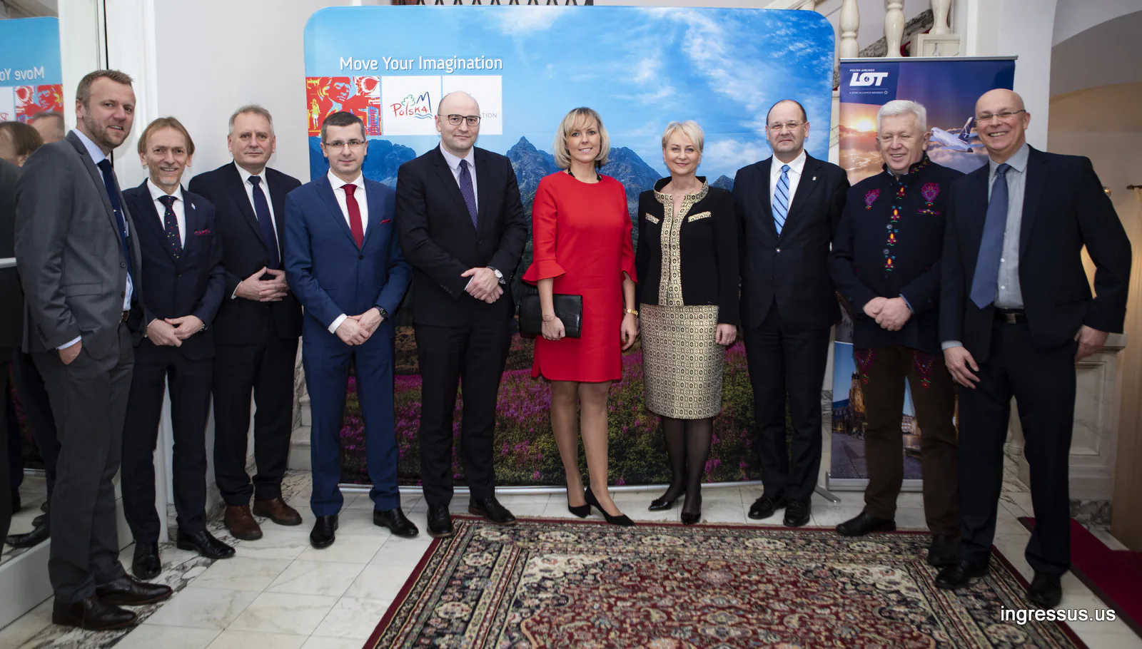 Hosts and guests of the Małopolska promotional event at the Polish Consulate General in Chicago, posing by Polish Tourism and LOT banners
