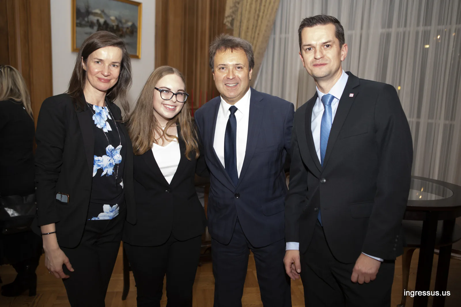Four guests smiling for a photo in a reception room during the promotional event at the Polish Consulate General in Chicago