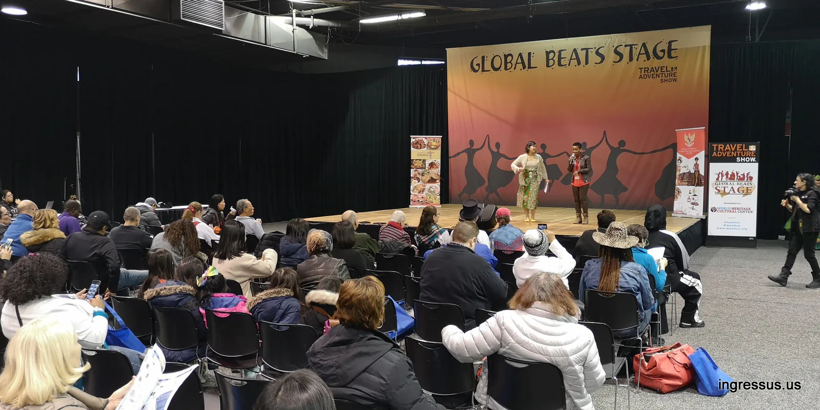 Audience watching two presenters on the Global Beats Stage at the 2020 Travel & Adventure Show in Rosemont