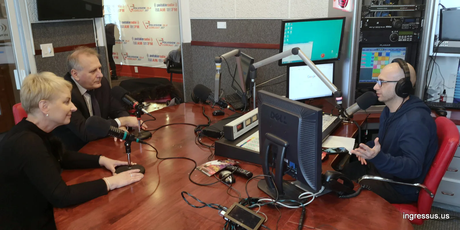 Radio interview at the Polskie Radio studio in Chicago, with two guests at microphones across the desk from the host