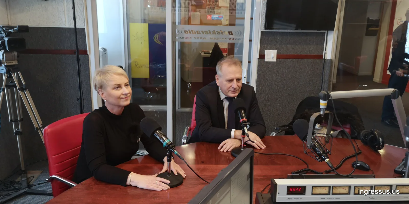 Two guests smiling at microphones in a Chicago radio studio during a promotional interview