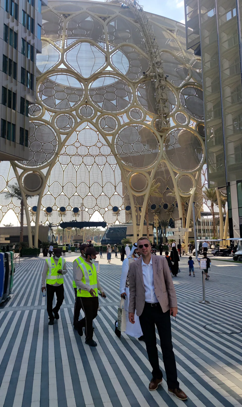 Trade mission participant on the striped plaza below the lattice dome of Al Wasl Plaza at Expo 2020 Dubai