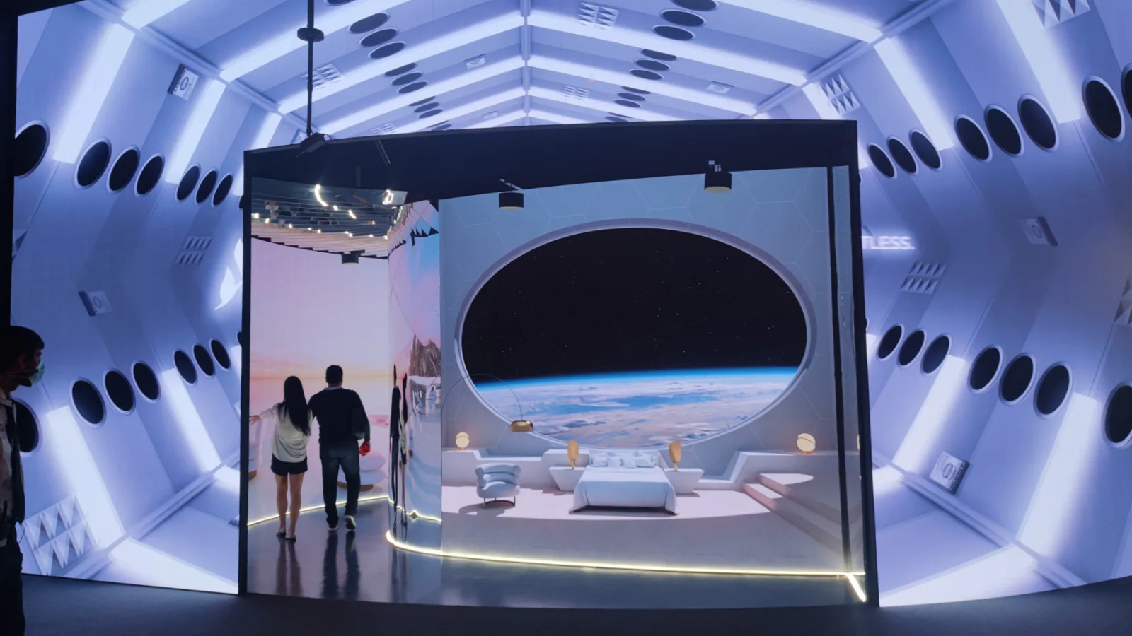 Pavilion exhibit showing a futuristic space hotel room with a round window looking down on Earth