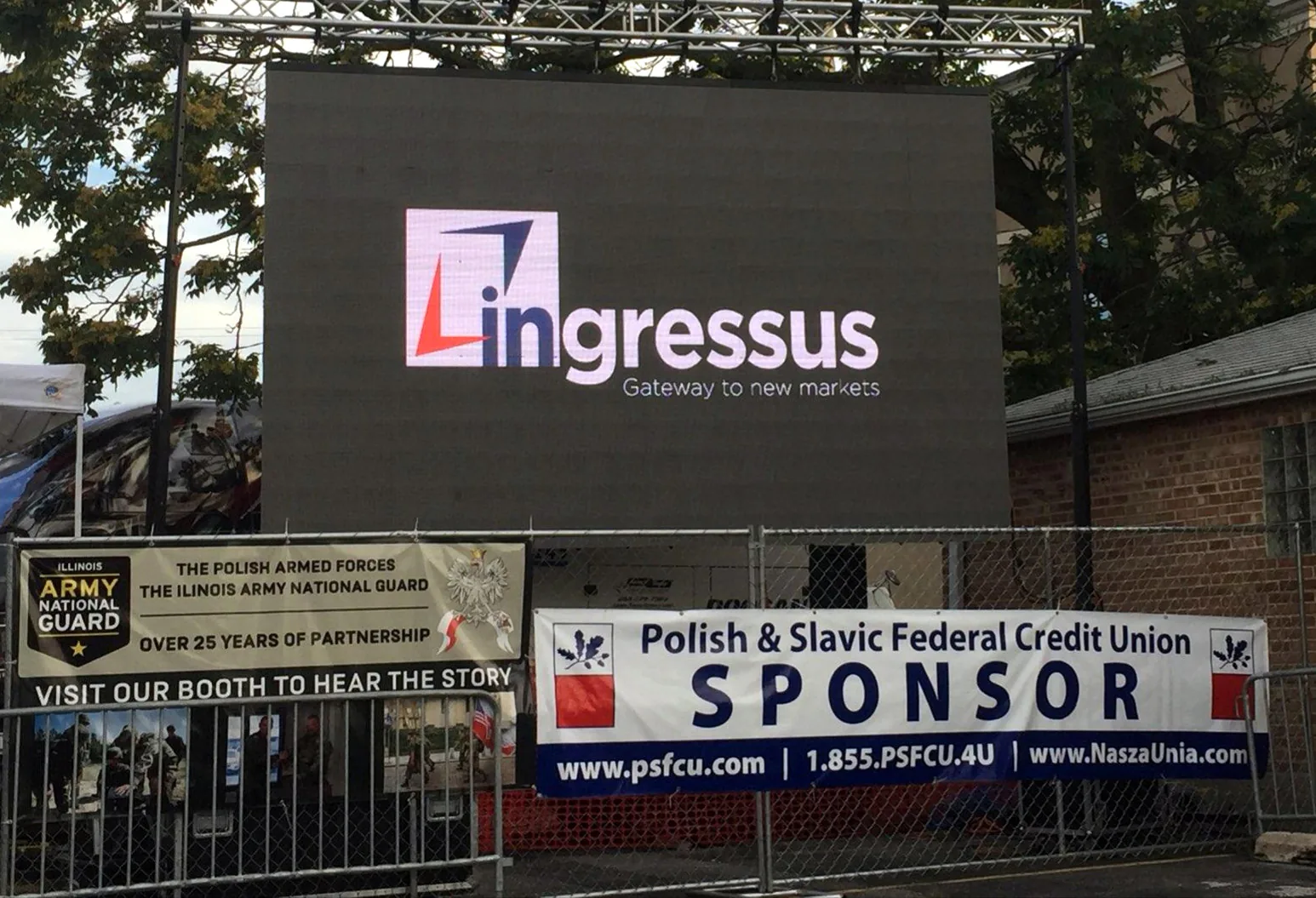 Large LED screen showing the Ingressus logo above Illinois Army National Guard and Polish & Slavic Federal Credit Union sponsor banners