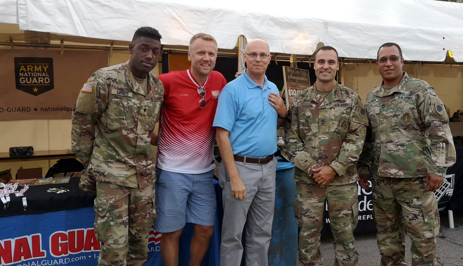 Illinois Army National Guard soldiers posing with two festival guests at the National Guard booth at Taste of Polonia 2019