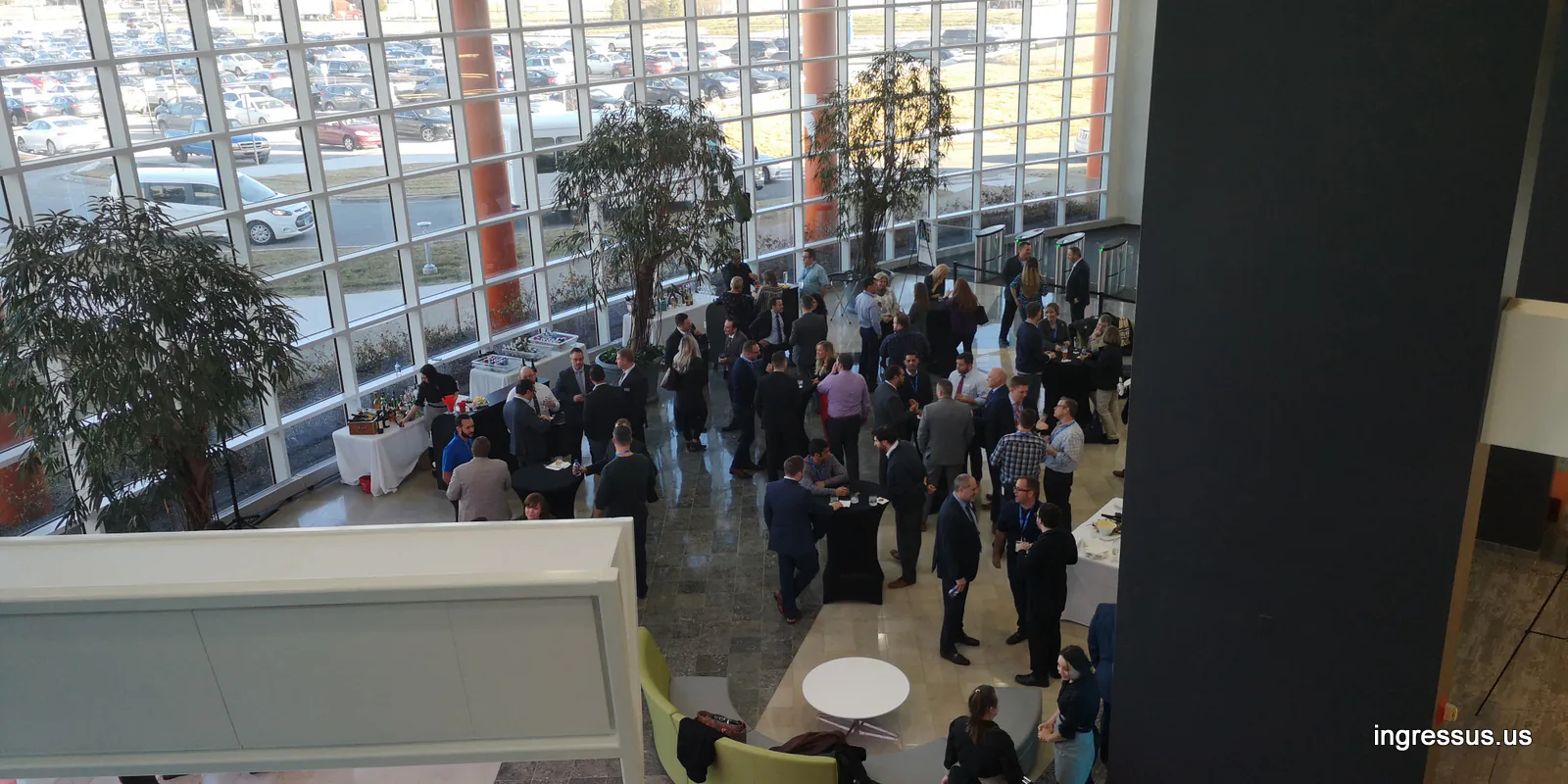 Success Track participants networking in the glass atrium of United Wholesale Mortgage headquarters, seen from above