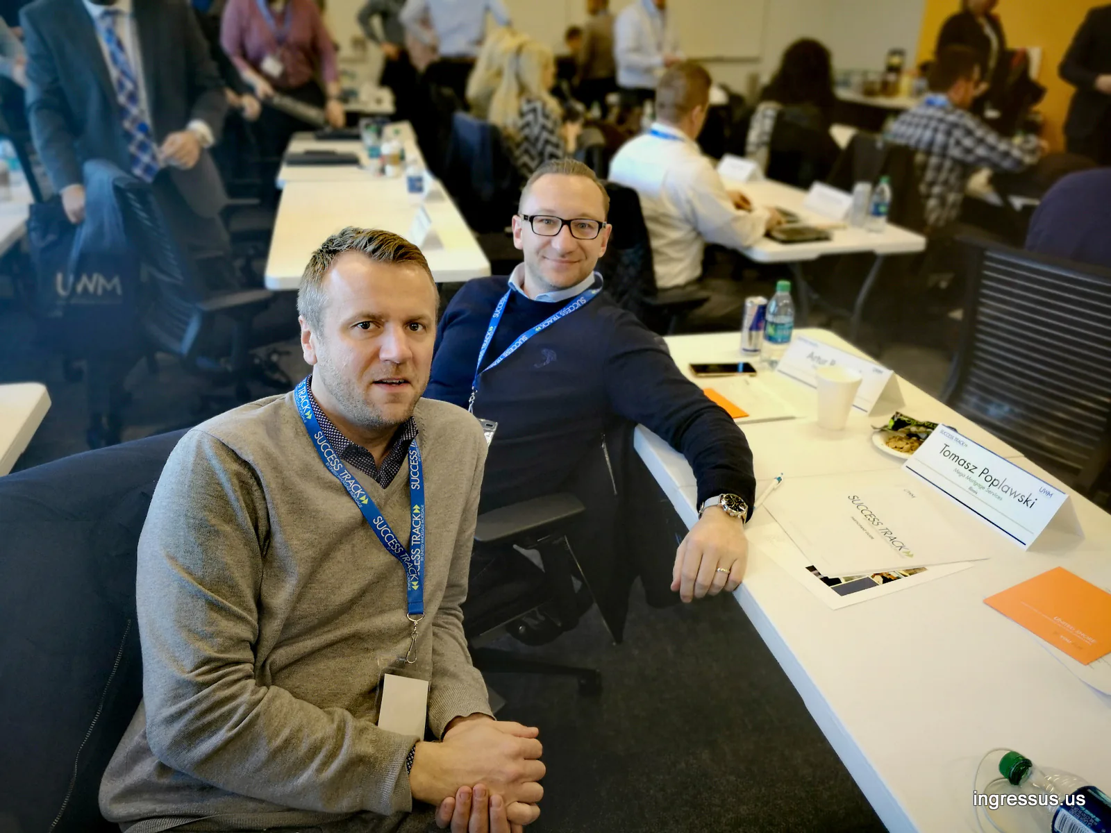 Ingressus with Artur Bartosik of Mega Mortgage Services at a Success Track training table with name cards, UWM headquarters